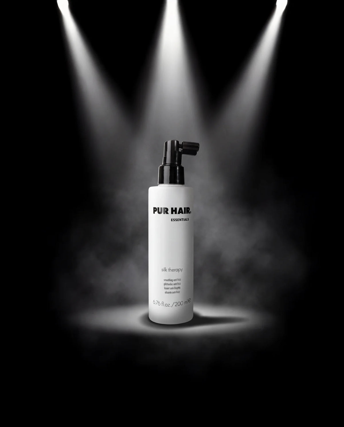 PUR HAIR Silk Therapy Leave-in im Spotlight mit schwarzem Hintergrund.