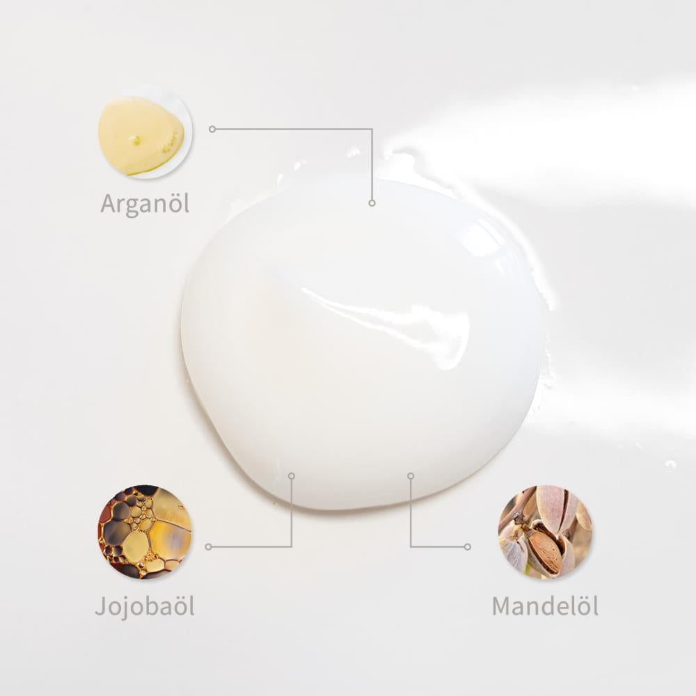 Weiße Creme-Textur mit markierten Inhaltsstoffen: Arganöl, Jojobaöl und Mandelöl